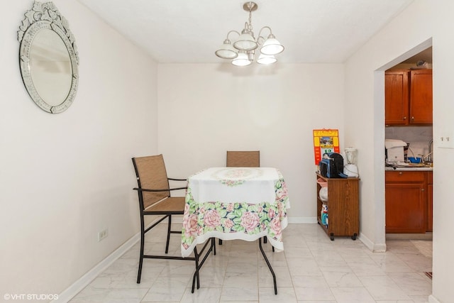 dining area with baseboards, marble finish floor, and a chandelier