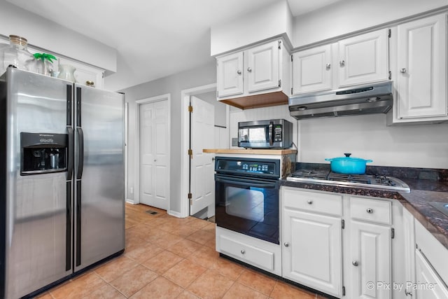 kitchen with under cabinet range hood, white cabinets, and appliances with stainless steel finishes