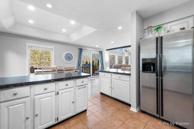 kitchen featuring recessed lighting, a raised ceiling, white cabinets, and stainless steel fridge with ice dispenser