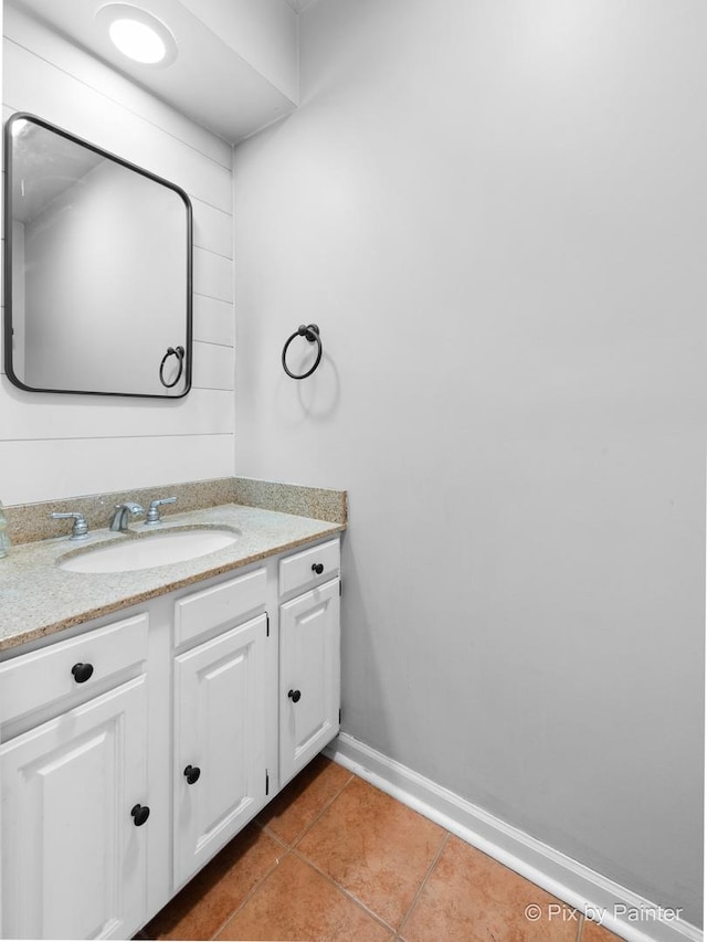 bathroom with tile patterned floors, baseboards, and vanity