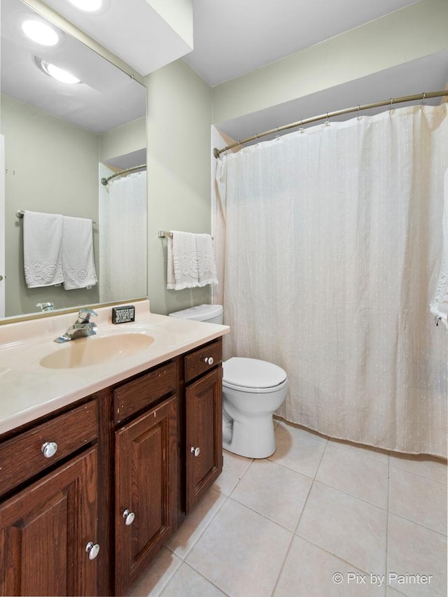 full bathroom featuring tile patterned flooring, toilet, and vanity