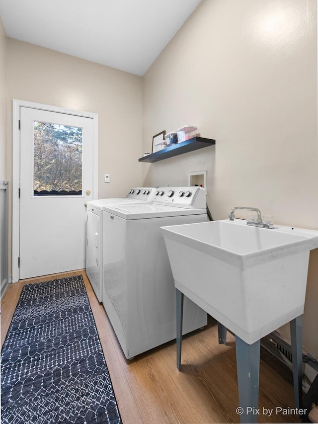 laundry room with light wood-style floors, independent washer and dryer, and laundry area