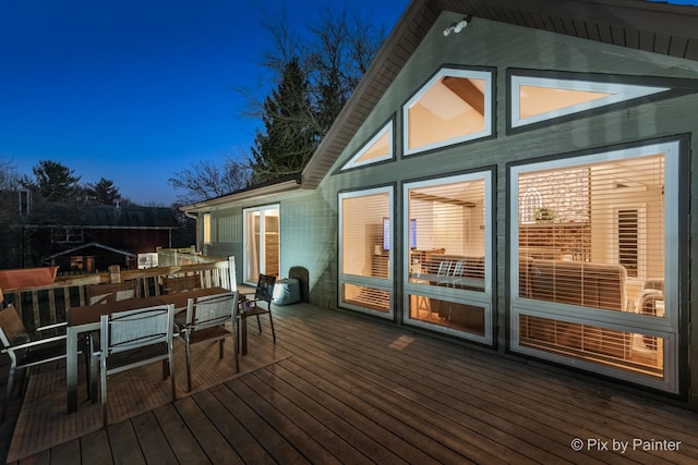 wooden terrace with outdoor dining area