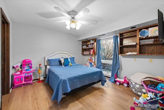 bedroom with ceiling fan and wood finished floors