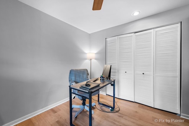 office area with wood finished floors, baseboards, and ceiling fan