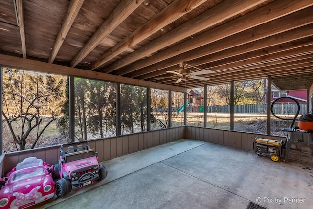 unfurnished sunroom featuring ceiling fan