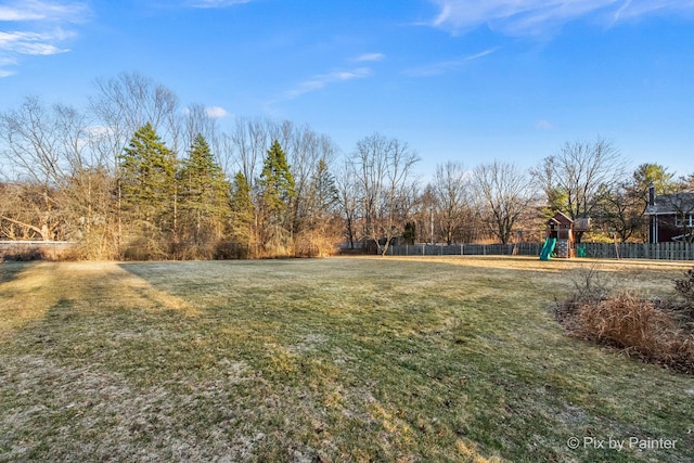 view of yard with playground community and fence