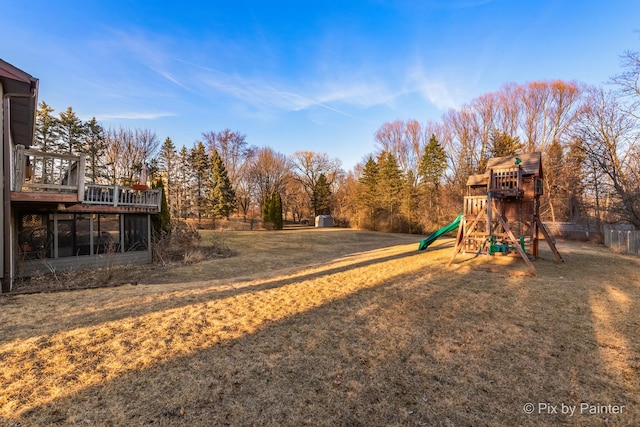 view of yard with a wooden deck and a playground