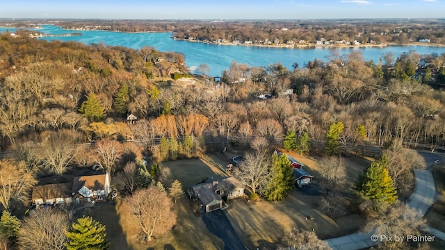 aerial view featuring a wooded view and a water view