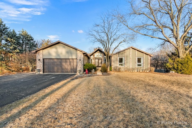 mid-century home with an attached garage and driveway