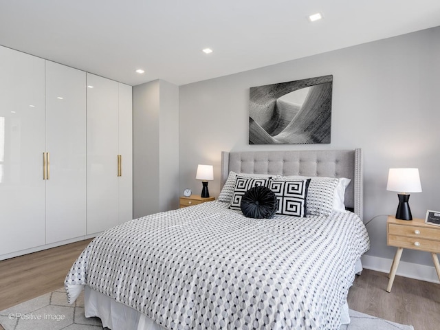 bedroom featuring recessed lighting, baseboards, and light wood finished floors