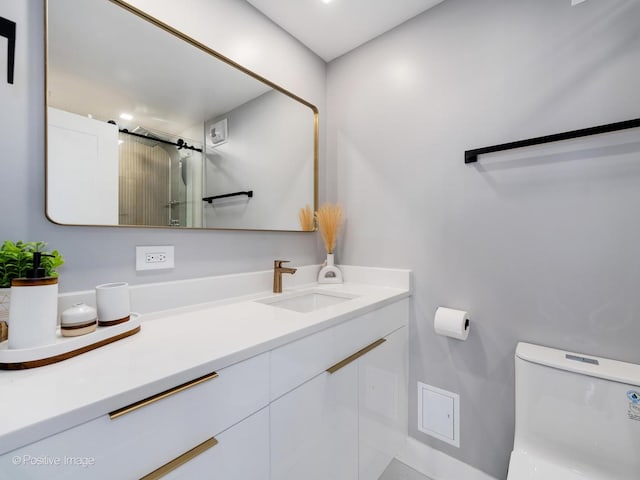 bathroom featuring an enclosed shower, toilet, and vanity