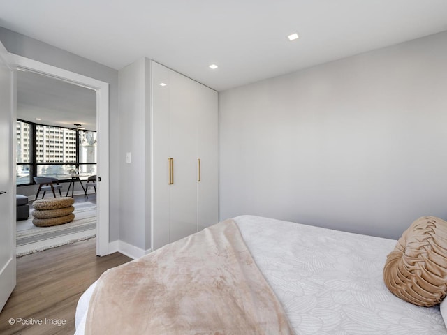 bedroom featuring recessed lighting, baseboards, and wood finished floors