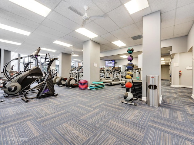 exercise room featuring visible vents, baseboards, ceiling fan, carpet floors, and a paneled ceiling