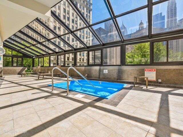 view of swimming pool with a view of city and a pool