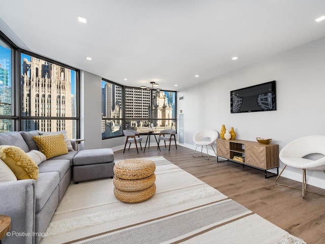 living area with recessed lighting, baseboards, and wood finished floors