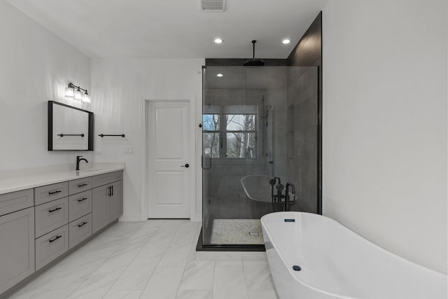 full bathroom with vanity, a soaking tub, recessed lighting, a stall shower, and marble finish floor