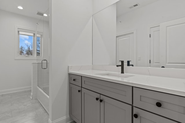 full bath with visible vents, baseboards, enclosed tub / shower combo, and vanity