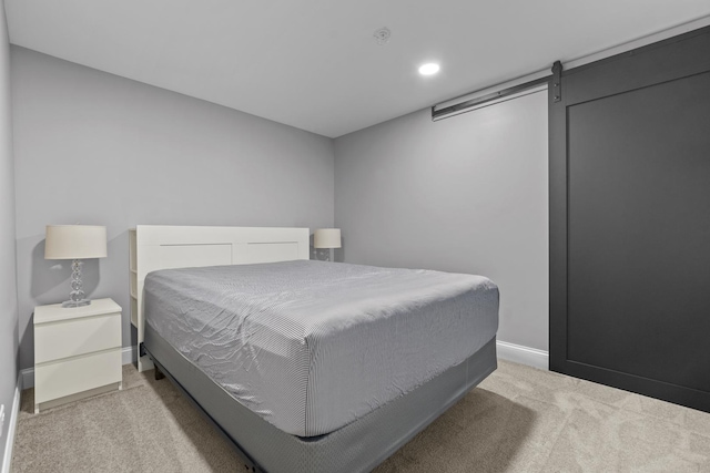 bedroom featuring light colored carpet and baseboards