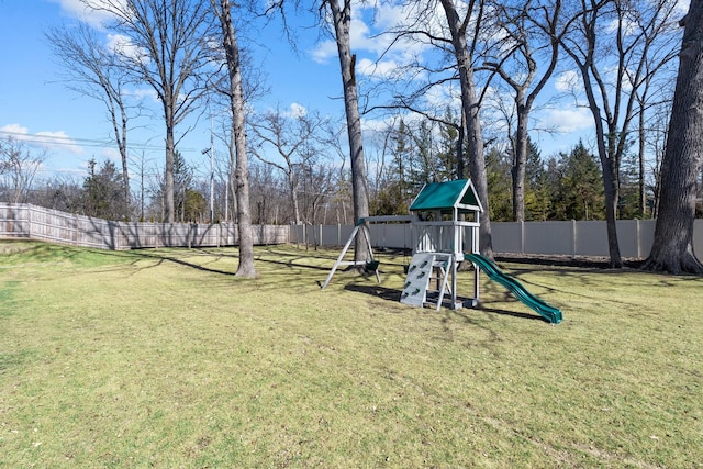 view of play area featuring a lawn and a fenced backyard