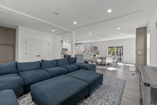 living area with recessed lighting and light wood-style floors