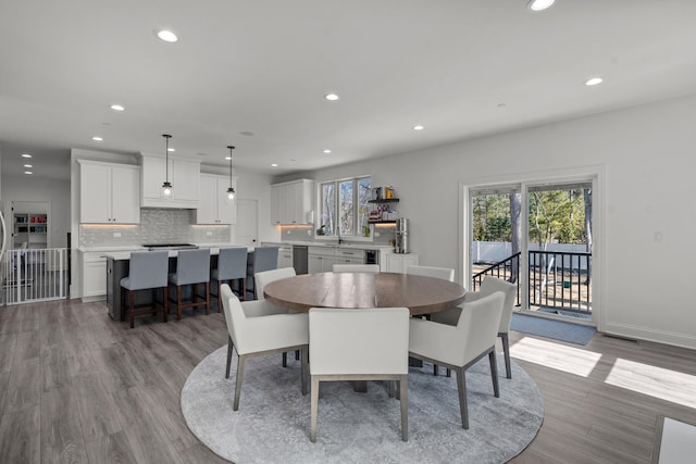 dining area featuring recessed lighting, wood finished floors, and baseboards