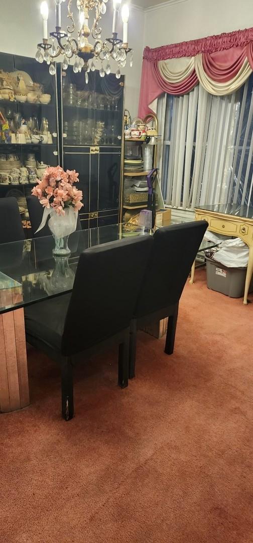 sitting room with carpet and a chandelier
