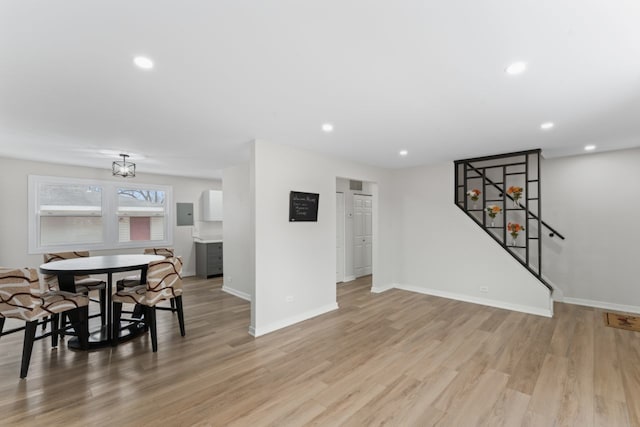 living room featuring recessed lighting, baseboards, and light wood-type flooring