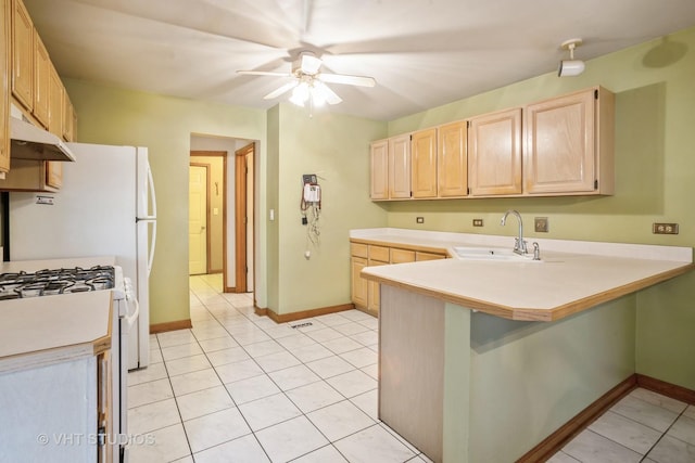 kitchen with light brown cabinetry, a sink, under cabinet range hood, a ceiling fan, and white range with gas cooktop
