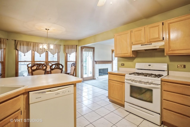 kitchen featuring white appliances, under cabinet range hood, a chandelier, light brown cabinetry, and light countertops