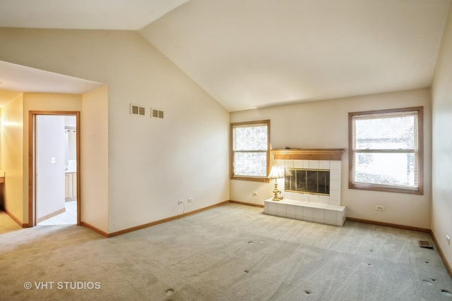 unfurnished living room featuring vaulted ceiling, carpet flooring, baseboards, and a fireplace