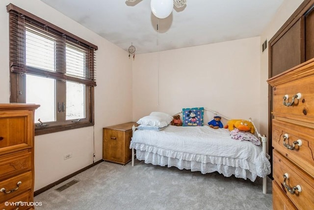 bedroom featuring ceiling fan, light colored carpet, visible vents, and baseboards