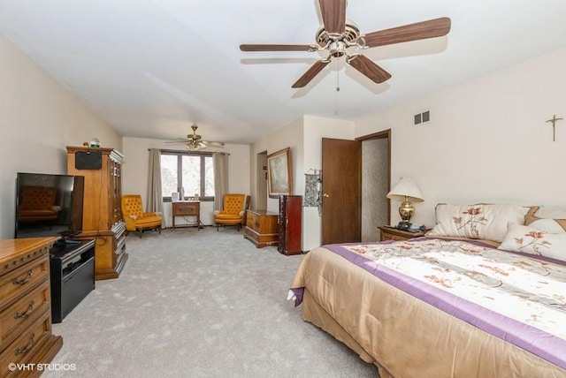 bedroom with a ceiling fan, light colored carpet, and visible vents