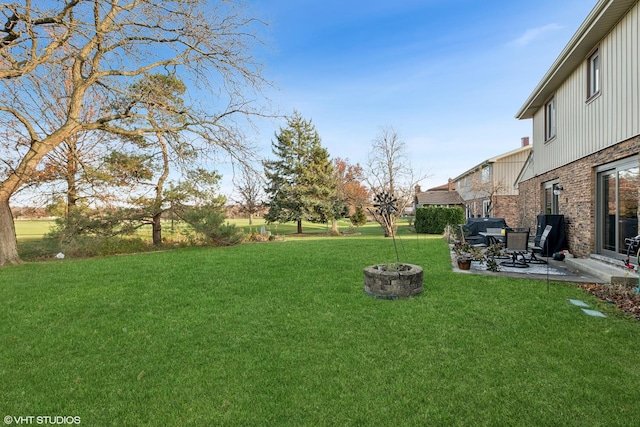 view of yard with a patio area and an outdoor fire pit