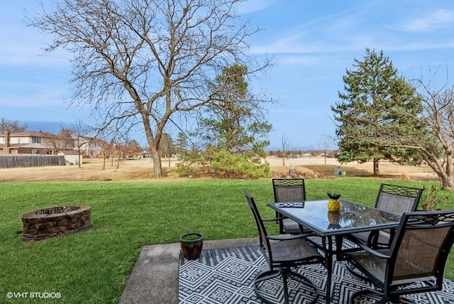 view of patio with outdoor dining area and a fire pit