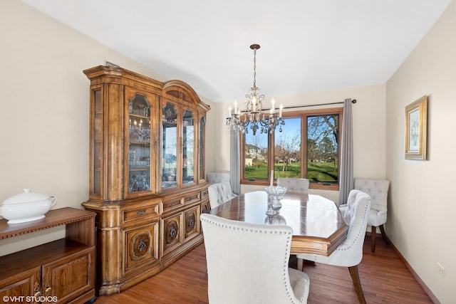 dining space with an inviting chandelier and wood finished floors