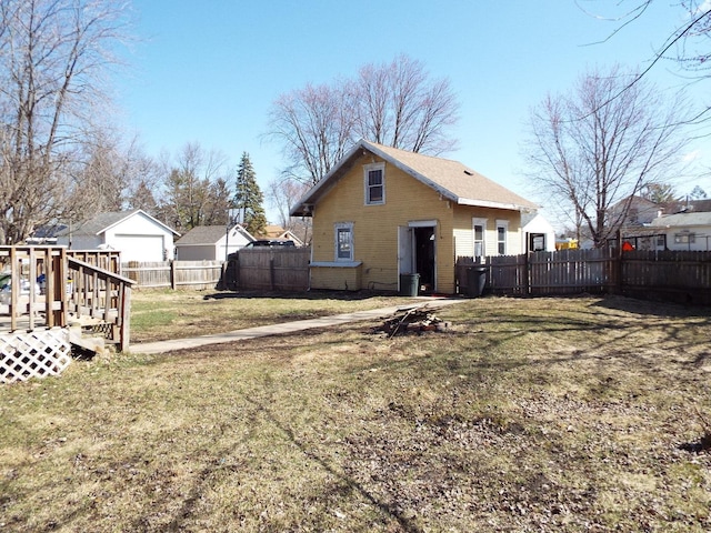410 S Franklin Ave, Polo, IL 61064 - rear view of property featuring a fenced backyard and a lawn