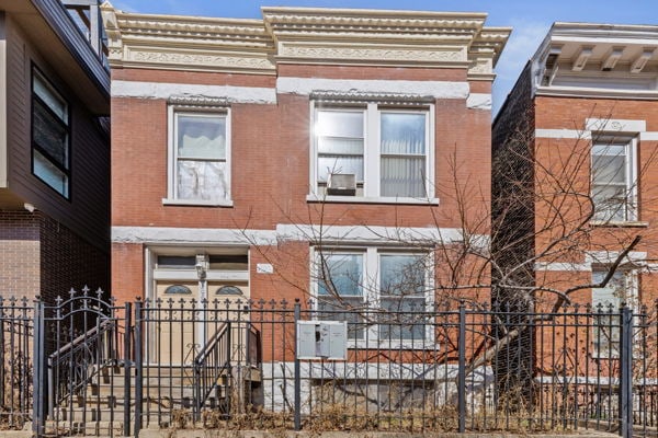 2020 W Superior St, Chicago, IL 60612 - townhome / multi-family property featuring brick siding and a fenced front yard