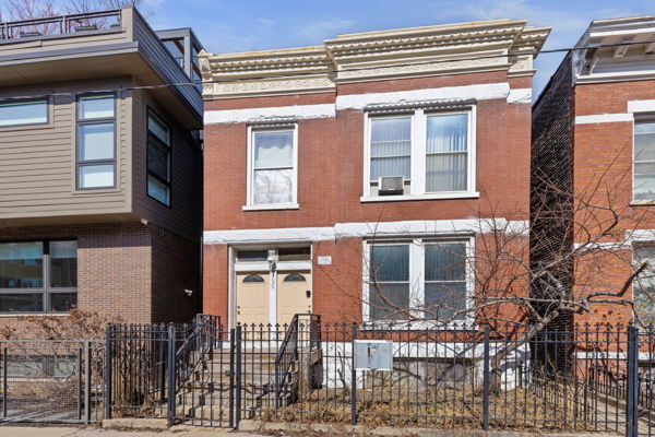 2020 W Superior St, Chicago, IL 60612 - townhome / multi-family property featuring a fenced front yard and brick siding