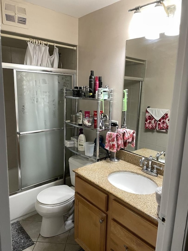 full bathroom with tile patterned floors, visible vents, toilet, enclosed tub / shower combo, and vanity