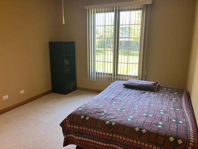 bedroom with carpet flooring and baseboards