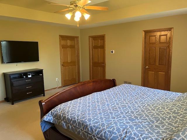 bedroom with a ceiling fan and carpet floors