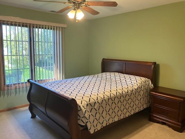 bedroom with carpet flooring, baseboards, and ceiling fan