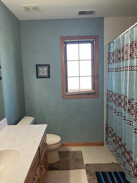 full bathroom featuring tile patterned flooring, toilet, vanity, and visible vents