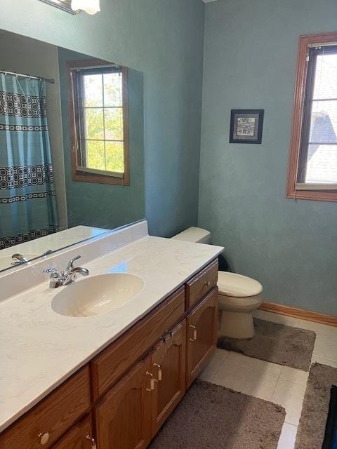 bathroom with toilet, a shower with shower curtain, tile patterned flooring, baseboards, and vanity