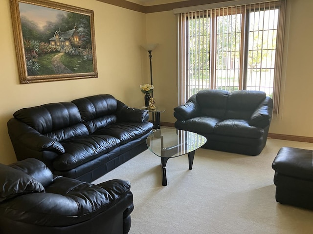 carpeted living area featuring baseboards