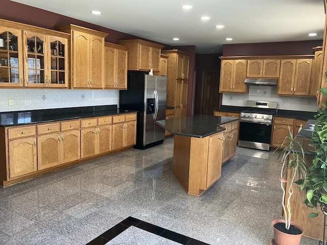 kitchen with granite finish floor, recessed lighting, under cabinet range hood, and stainless steel appliances