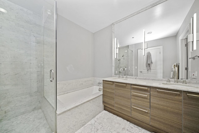 bathroom featuring double vanity, a garden tub, a stall shower, and a sink