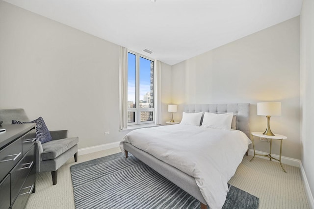 carpeted bedroom with visible vents and baseboards