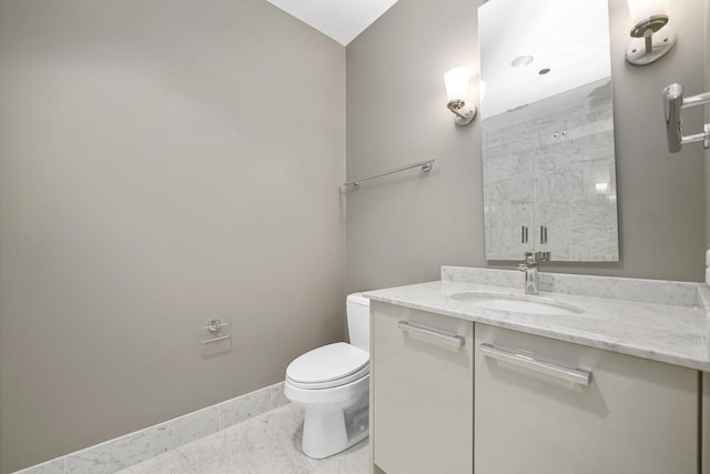 full bath with baseboards, toilet, vanity, and walk in shower